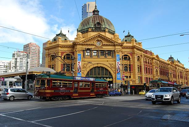 Flinders St Station - Melbourne Melbourne, Australia - April 11, 2010: Flinders St Station with the city circle tram in front.  Flinders St station is an icon of Melbourne and the city circle tram is provided free for locals and tourists, with a commentary of the city and its landmarks as it travels. melbourne street crowd stock pictures, royalty-free photos & images