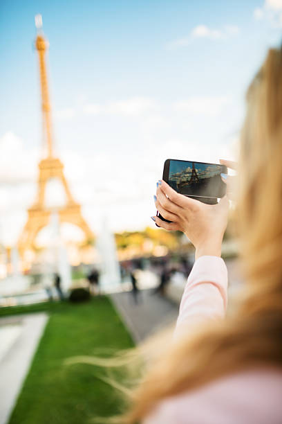 istock woman photographing on paris ith the tour eiffel 539094889