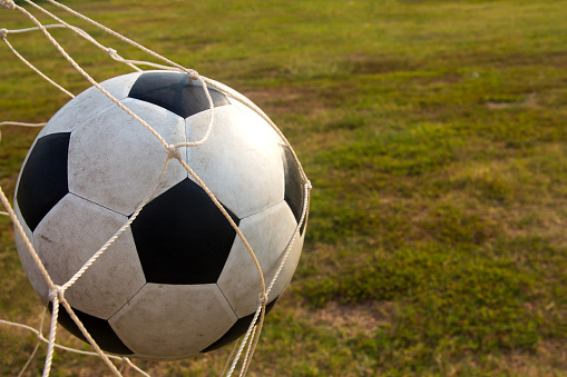 football on the goal net, success concept,scoring