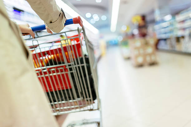 istock Woman pushing shopping trolley 539097520