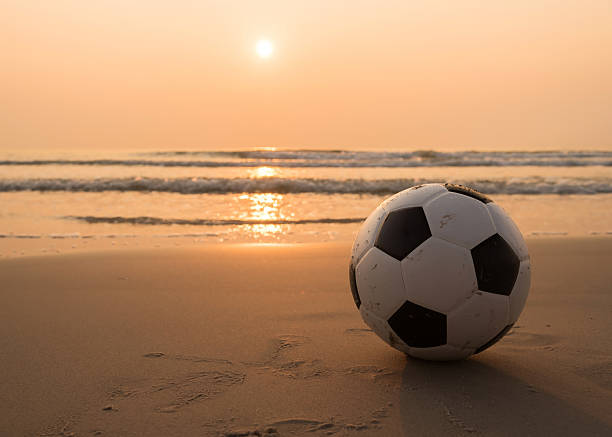 Football on the beach stock photo