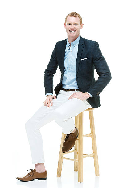 istock Smiling fashionable man sitting on stool 539099380