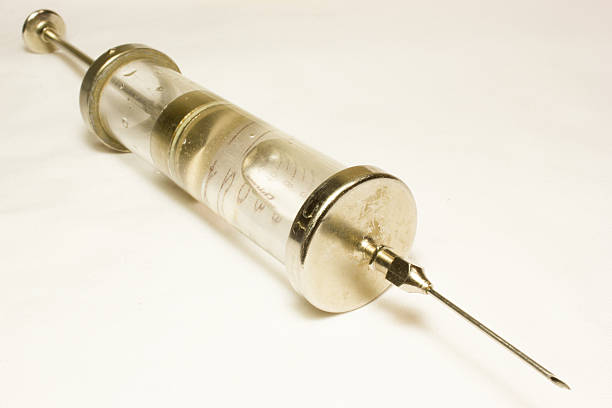 glass syringe filled with green liquid isolated on white background