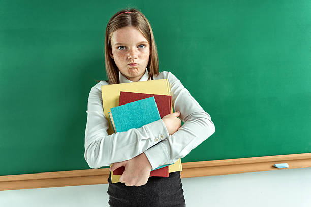 istock Resentful little girl hugging school books. 539101908
