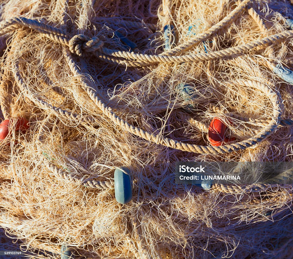 Fishing trammel net tackle texture in Gandia port Fishing trammel net tackle texture in Gandia port of Valencia Spain Brown Stock Photo