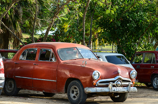 Trinidad, Cuba - December  9, 2014: Classic American car park on sea front in Trinidad, Cuba.Cuba is known for the beauty of its vintage cars