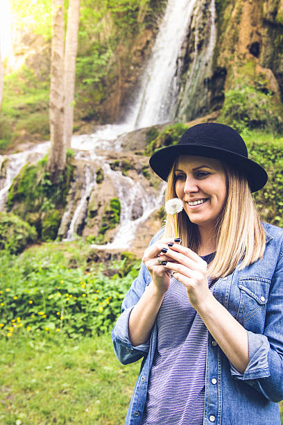 istock woman blowing on a dandelion 539104578