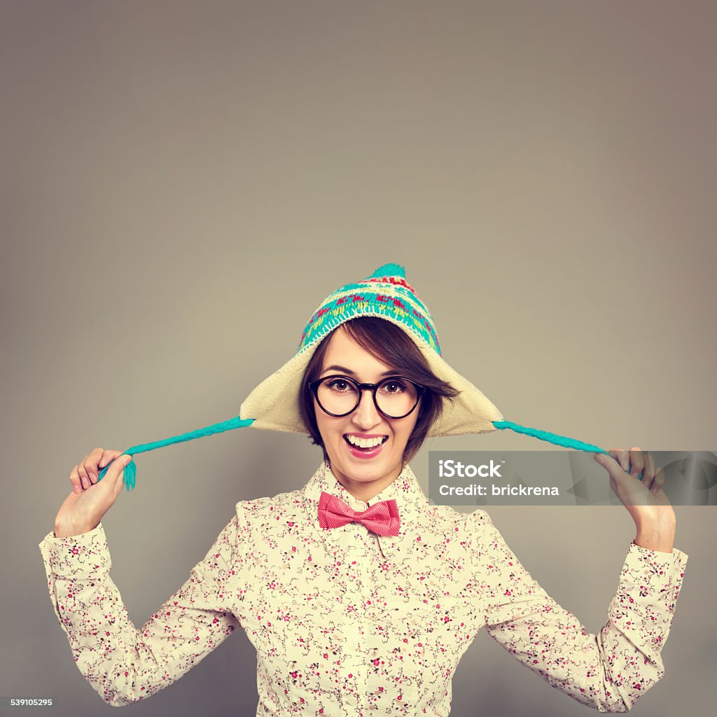 Portrait of Funny Hipster Girl in Winter Hat Studio Portrait of Smiling Hipster Girl in Funny Winter Hat Fooling Around and Tease. Copy Space. Instagram Styled Filtered Photo. 2015 Stock Photo