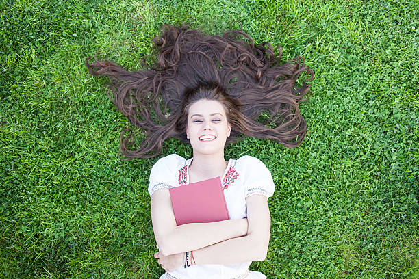 istock Smiling young woman embracing a book 539105498