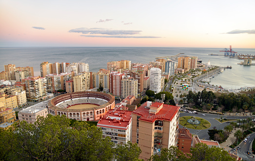 A view from above of Malaga city and port area. The picture shows some of the more modern apartment buildings and office blocks in the city surounding the Port area. Taken just before sunset. no filters were used on this file.