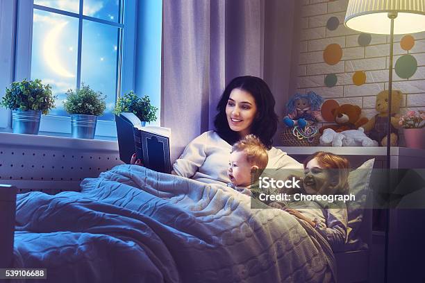 Mother Reading A Book Stock Photo - Download Image Now - Storytelling, Baby - Human Age, Child