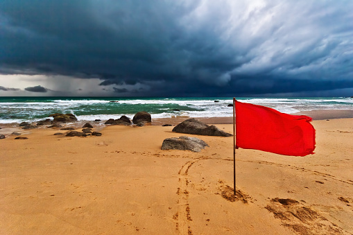 Red warning flag at beach. Phuket, Thailand.