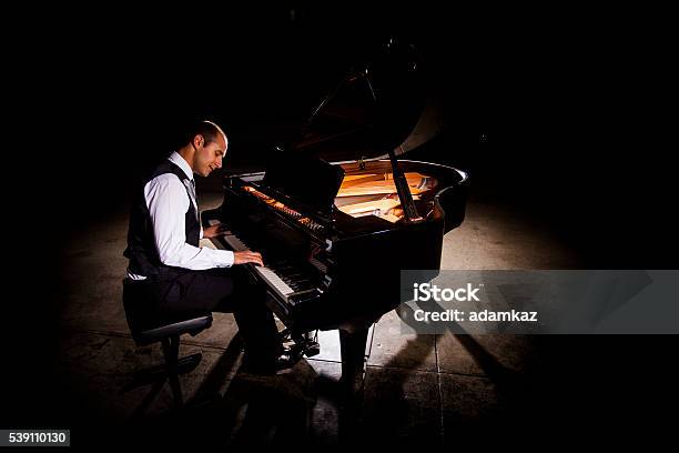 Man Playing Piano With Dramatic Lighting Stock Photo - Download Image Now - Piano, Pianist, Men