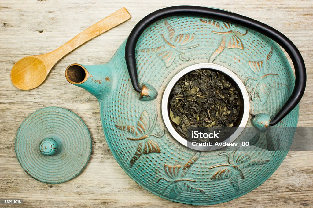 Blue cast iron kettle, dry green tea. Top view Backgrounds Stock Photo