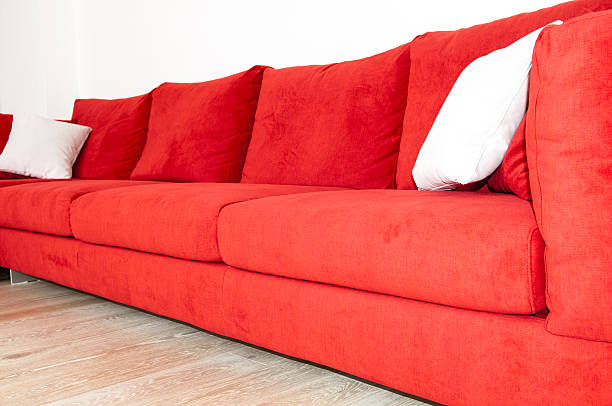 istock Red sofa and white pillow a wooden parquet floor 539111146
