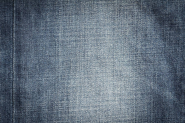 istock Closeup denim jeans texture. Stitched textured blue denim jeans. 539111224