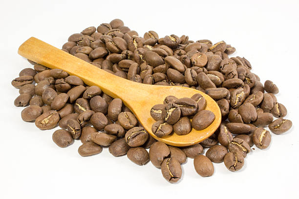 istock Coffee beans and spoon on white background 539111734