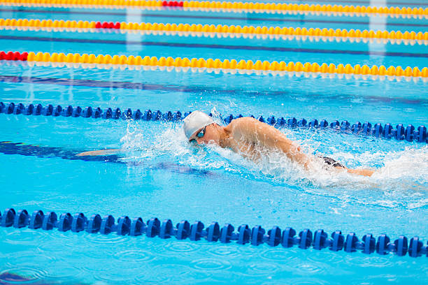 istock Man swimmer swimming crawl in blue water. 539112500