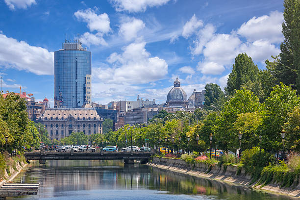 Central Bucharest, Romania Late spring in Bucharest. View towards the Dambovita river, in the background among other buildings, the tall financial plaza building and the roof of the CEC palace. bucharest photos stock pictures, royalty-free photos & images