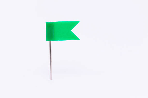 istock Green flag pin isolated white background 539115232