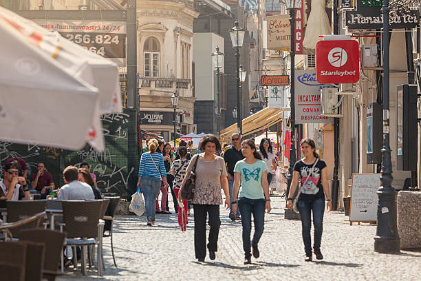 Bucharest, Romania - May 28, 2016: Tourists and shopping locals walking along the historical Lipscani street lined with restaurants, bars and stores in the old town of Bucharest.