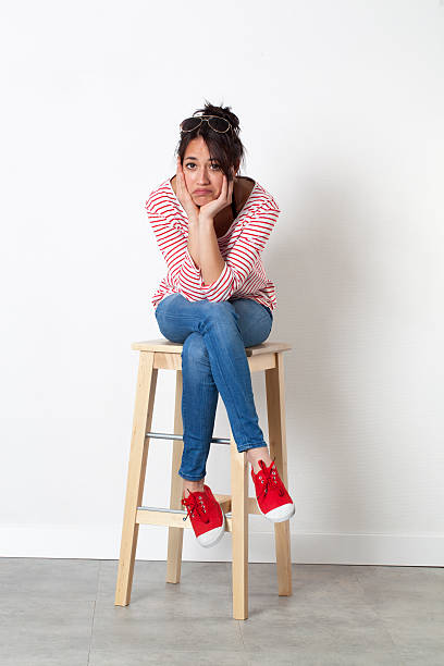 istock bored young female student looking disappointed and resigned, sitting 539117658