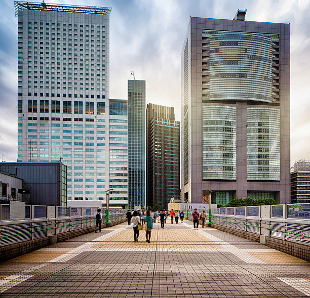 Shinjuku Overpass with modern buildings and dramatic sky