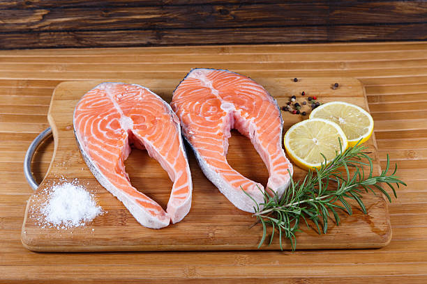 istock Raw salmon with lemon on wooden table 539118541