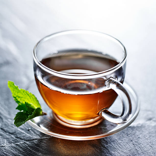 istock glass of hot tea with mint garnish 539118943