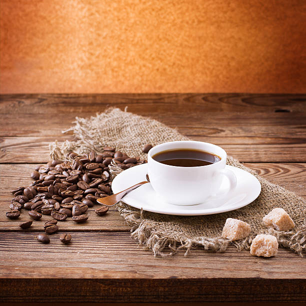 istock Coffee cup and saucer, tablecloth on wooden desk. 539119016