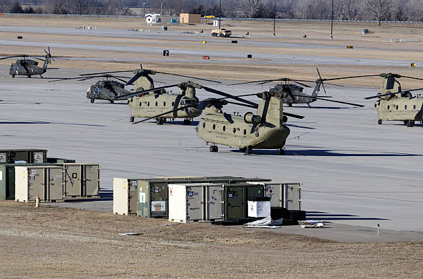 Chinook and Black Hawk Helicopters Fort Riley, KS, USA - February 8, 2015: Chinook and Black Hawk helicopters parked on the tarmac at Fort Riley, Kansas. Fort Riley is a United States Army Installation and home of the 1st Infantry Division. blackhawk stock pictures, royalty-free photos & images