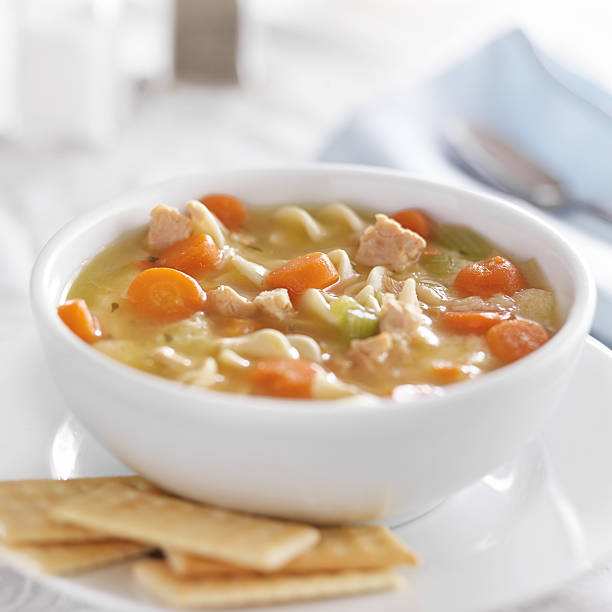 istock bowl of chicken noodle soup on white table cloth 539119559