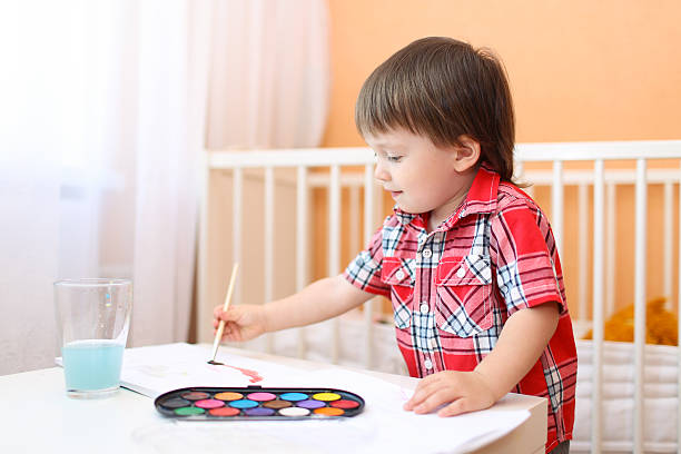 istock lovely little boy with brush and paints 539119867