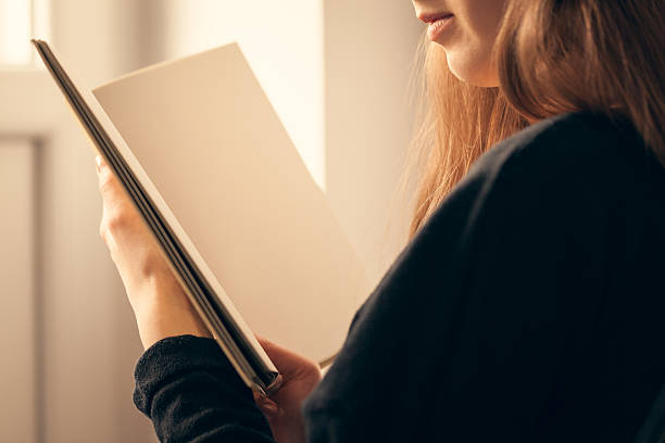 istock Close up of woman hands holding open book. 539122206