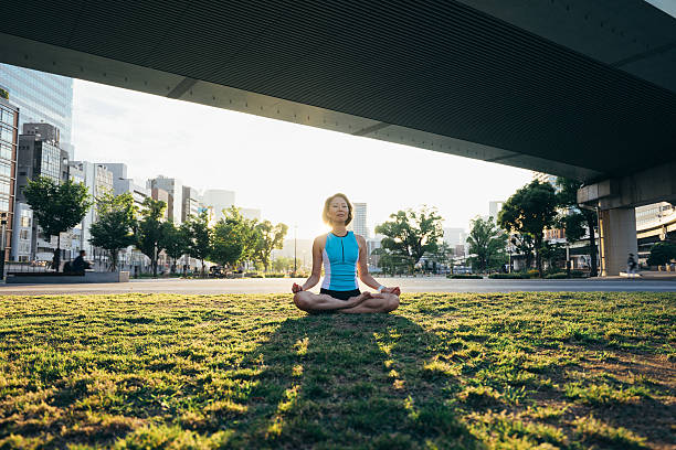 istock Woman Meditating Under The Bridge At Sunset 539122328