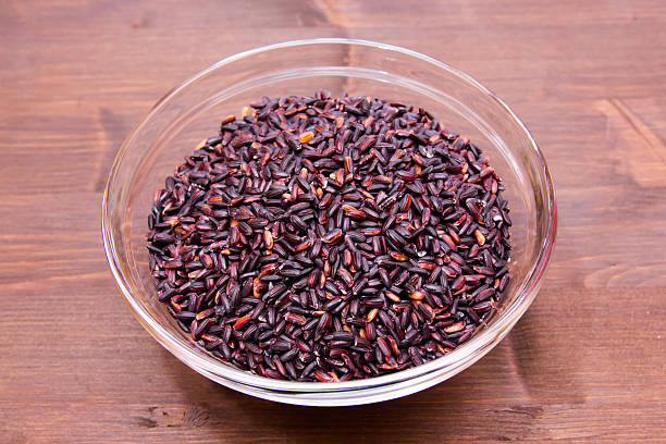 istock Bowl with black rice on wood 539122998