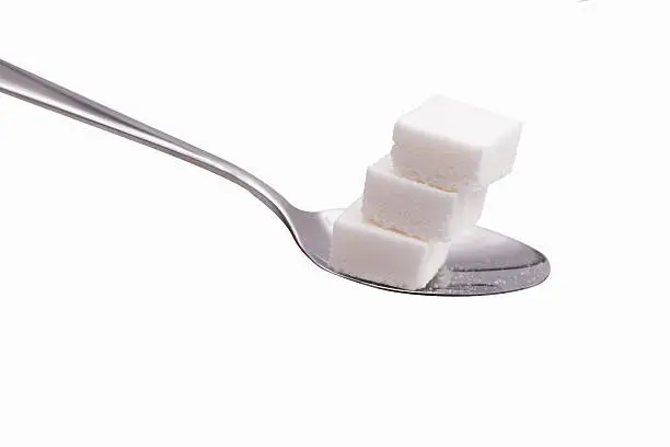 sugar cubes in aspoon isolate on white with clipping paths