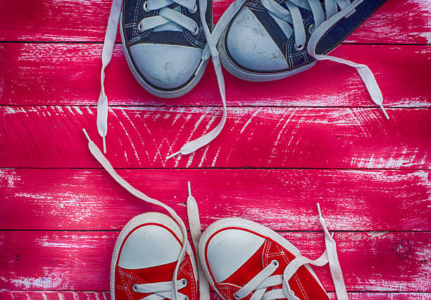istock Two pairs of sneakers on a pink background 539124938