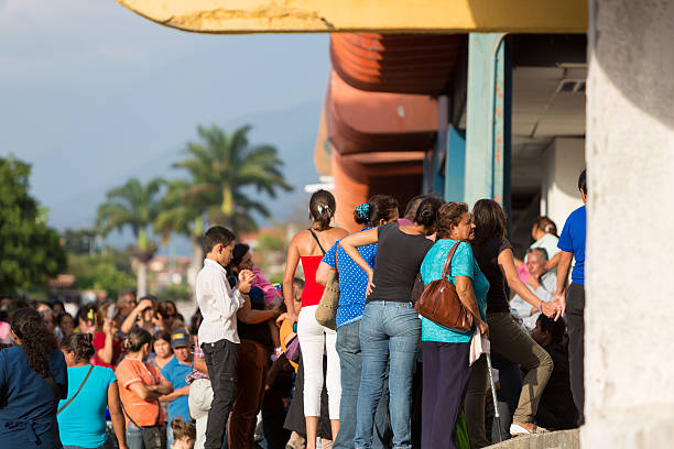 Group of people waiting in line at public supermarket, Venezuela stock photo