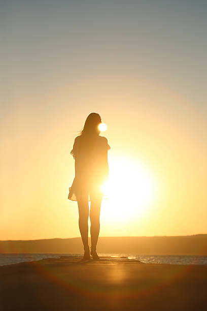 istock Young woman enjoying the sunset 539128096