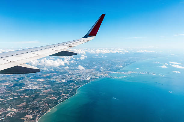istock airplane wing above the seashore 539129388