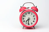 Close-up of Pink Table Alarm Clock on White Background