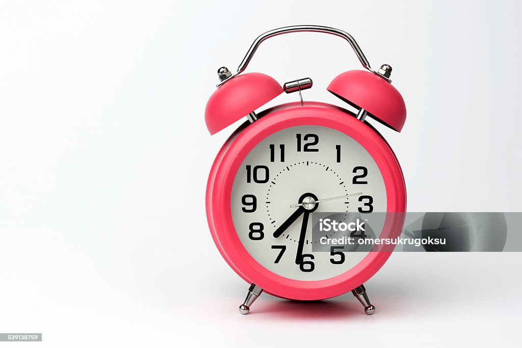 Close-up of Pink Table Alarm Clock on White Background Classic alarm clock isolated on white background. Alarm Clock Stock Photo