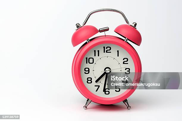 Closeup Of Pink Table Alarm Clock On White Background Stock Photo - Download Image Now