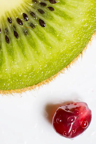 Photo of Kiwi slice and pomegranate seeds, Macro