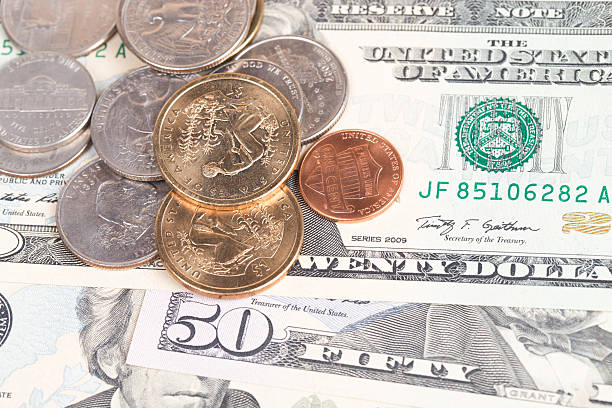 istock US coins on US banknotes close up 539141871