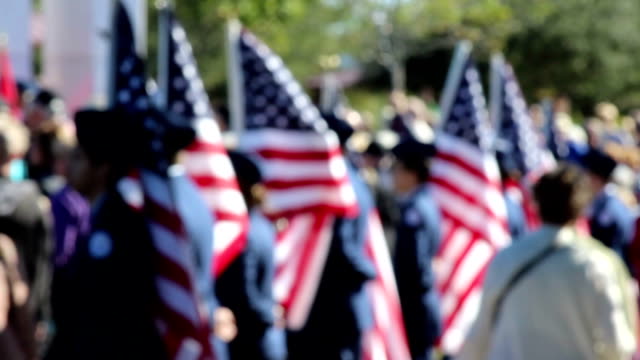 American Flag bearers in soft focus