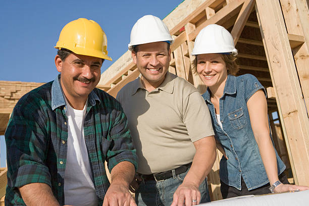 istock Two men and woman at construction site, portrait 539148081