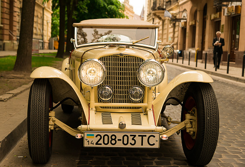 Lviv, Ukraine - May 11.2014: Old car brand OPEL downtown near City Philharmonic. The owner of the car is waiting in the cabin passengers who at the time of the shooting out of the building Philharmonic