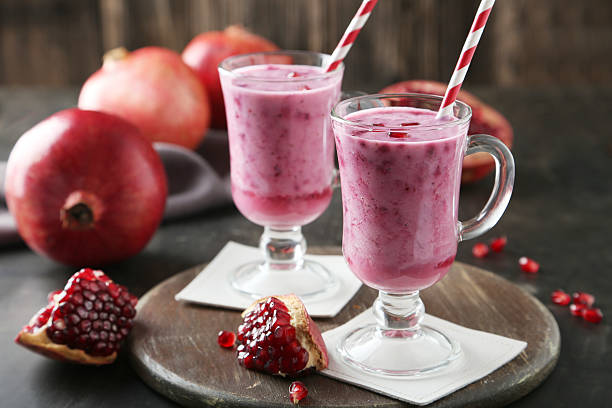istock Pomegranate smoothie in glass on black background 539150371
